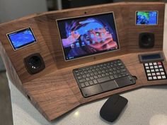 a desk with a keyboard, mouse and monitor on it that is made out of wood