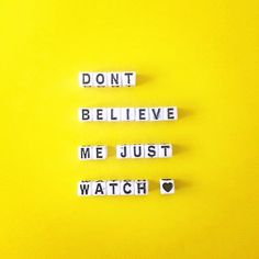 the words don't believe me just watch are spelled in small blocks on a yellow background