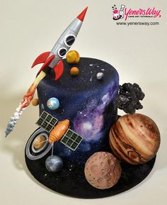 a space themed birthday cake with planets and rockets