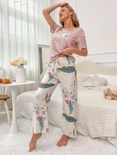 Elevate your comfort with our Floral Print Tee And Pants Pajama Set. Experience the joy of our exquisite cartoon and floral patterns, beautifully complemented by a delicate knot detail. Designed for relaxation, this 2-piece set features a round neck, short sleeves, and a regular fit. Crafted from high-quality knitted fabric with medium stretch, it offers both style and ease. Specifications: Pattern Type: Cartoon, Floral Type: Pant Sets Neckline: Round Neck Details: Knot Sleeve Length: Short Slee Casual Floral Print Sets For Sleepover, Casual Floral Print Sleepover Sets, Floral Print Sleepwear For Pajama Party, Pink Floral Print Lounging Set, Pink Floral Print Loungewear Sets, Casual Pink Floral Print Sleepwear, Spring Floral Print Sleep Bottoms, Floral Print Sleep Bottoms For Spring, Spring Sleep Bottoms With Floral Print