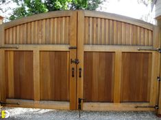 a large wooden gate in front of a house