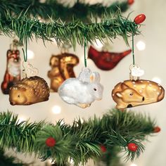 a christmas tree with ornaments hanging from it's branches in the shape of animals