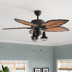 a ceiling fan in a living room with blue walls