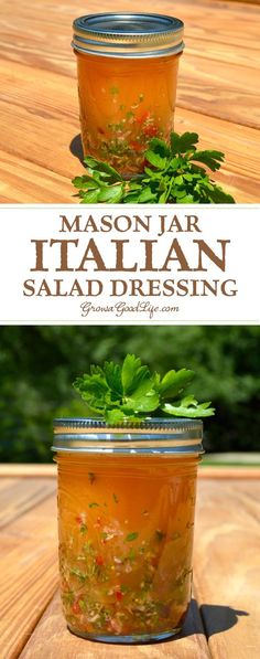 mason jar filled with salad dressing sitting on top of a wooden table next to another jar