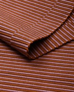 a close up view of a brown and white striped fabric