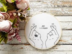 a embroidery kit with two hands holding hearts and the words i love you written on it