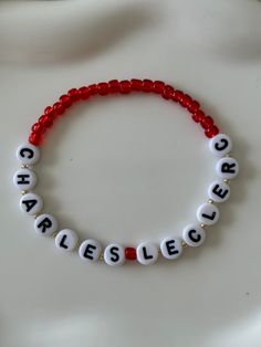 a red beaded bracelet with white letters that spell out the word fearless on it