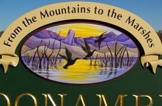 there is a sign that says oonambi from the mountains to the marshes