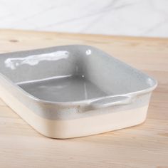 a white ceramic dish sitting on top of a wooden table