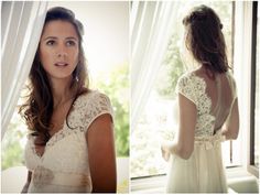 a woman in a white dress standing next to a window