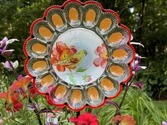 there is a glass plate with flowers in the middle of it and an image of a bird on it