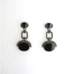 This is part of Chairish’s Fine Jewelry assortment.  A beautiful pair of black onyx and sterling silver Art Deco style dangle earrings, circa mid to late-20th century. A great pair to dress up or down. Each are marked on back 'Sterling' as shown in last three images. Excellent condition as shown in images. No issues. Dimensions: 1.5" Long. Elegant Black Oval Earrings, Black Art Deco Earrings For Evening, Black Clip-on Jewelry For Formal Occasions, Vintage Oxidized Black Jewelry, Black Vintage Oxidized Jewelry, Luxury Black Sterling Silver Earrings, Black Oval Earrings For Formal Occasions, Vintage Black Oval Earrings, Modern Black Enamel Earrings For Formal Occasions