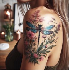 a woman with a dragon tattoo on her shoulder and flowers in the foreground, behind her is a pink flower