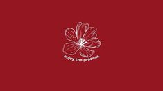 a red flower with the words enjoy the process written in white ink on a red background