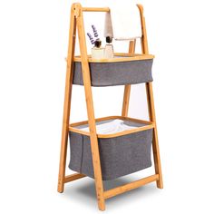 a wooden shelf with two baskets on it and a towel rack next to the basket