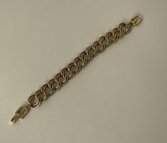 "Givenchy gold tone link chain bracelet  approximately - 8\" L with clasp x 5/8\" w.  Good vintage condition  marked: copyright symbol Givenchy  08/16/23 1428" Gold Metal Bracelet With Curb Chain, Gold Bracelet With Curb Chain Link, Gold Cuban Link Bracelet With Chain, Gold Cuban Link Bracelet With Chain Detail, Formal Metal Chain Bracelet With Adjustable Chain, Formal Gold-tone Metal Chain Bracelet, Gold-tone Chain Link Bracelets, Metal Cuban Link Bracelet With Gold Chain, Formal Cuban Link Metal Bracelets