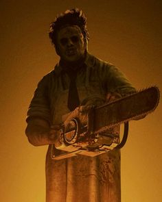 a creepy looking statue holding a chainsaw in front of a yellow background with an orange glow