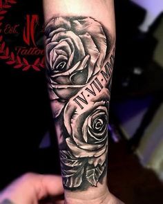 a black and white rose tattoo on the arm with words written in cursive writing