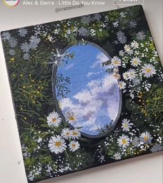 an image of a mirror in the middle of daisies and daisies around it