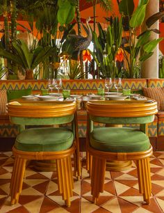 two green chairs sitting next to each other at a table