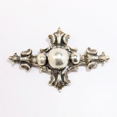 "This is a lovely Sterling silver gothic revival style brooch by Cini. The piece is hallmarked Sterling and signed on the back. The brooch is in excellent vintage condition with no visible flaws. The piece measures 2.8\" wide and 1.8\" long. It weighs .56 Troy ounces. If you have any questions or would like to see additional pictures, please contact us before making your purchase. Buyers outside the United States, please contact us for a shipping estimate." Victorian Antique Silver Brooches For Collectors, Victorian Antique Silver Brooches, Silver Victorian Engraved Brooch, Classic Silver Brooches With Intricate Design, Silver Engraved Victorian Brooches, Victorian Silver Engraved Brooch, Victorian Engraved Silver Brooch, Victorian Engraved Silver Brooches, Antique Silver Ornate Brooch For Formal Occasions