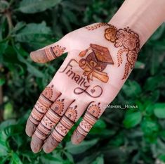 hendi design on the palm of a woman's hand that is decorated with flowers