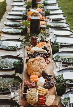 a long wooden table topped with lots of food