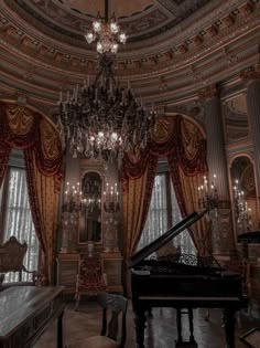 a grand piano is in the middle of a room with chandelier and curtains