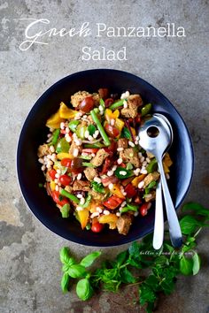 a bowl filled with meat and vegetables on top of a table next to a spoon