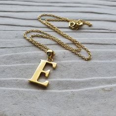 #E Gold Alphabet Pendant All other Alphabets are also available in the store.  Gemlogica is an American business and our motive is to create an honest and transparent company. We do not misrepresent our items and we strictly use ethically mined NATURAL gemstones and precious metals like sterling silver and gold. (we do not use brass, copper, zinc alloy, or any other base metals) ♥ Metal Type - Sterling Silver with Gold vermeil  ♥ Alphabet - E ♥ Metal Type (Main Photo) - High polish Sterling silv Gold Charm Necklace As A Gift With Polished Finish, Gold Charm Necklaces With Polished Finish For Gift, Gold Polished Finish Charm Necklace As Gift, Gold Polished Finish Charm Necklace For Gift, Classic Brass Necklace For Gift, Gold Initials Custom Necklace As Gift, Gold Initials Custom Necklace Gift, Gold Custom Necklace With Initials For Gift, Classic Gold Necklace As Gift