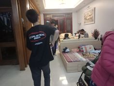 a man standing in front of a living room filled with furniture