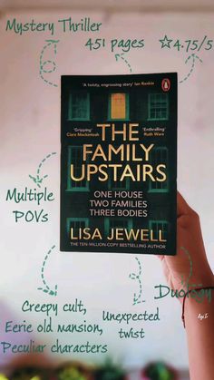 a person holding up a book about the family upstairss