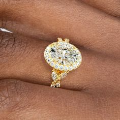 a woman's hand with a yellow and white diamond ring on top of her finger