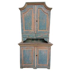 an old wooden cabinet with two doors and drawers on top of it, against a white background