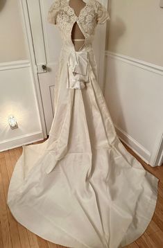 a wedding dress on display in front of a door