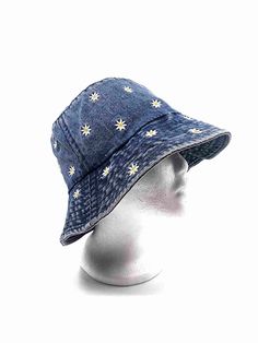 a white mannequin head wearing a blue hat with yellow stars on the side