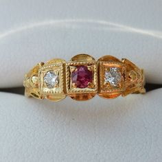 This is a lovely 18ct Ruby and Diamond 3/stone Victorian style ring. Hallmarked London 1987 . The ring is set with 1 x 0.10ct Ruby and 2 x 0.05ct Diamonds, round modern brilliant cuts. It is a nice low design, so less likely to catch. Please see my other Ruby & Diamond rings.. The ring is size N but can be made larger up to about a size R/S max if required. The tot wgt is 3.3 gms Victorian Wedding Ring, Rose Diamond Ring, Victorian Style Rings, Ruby Diamond Rings, Gold Engraving, Red Band, Ruby Diamond, Diamond Cluster Ring, Perfect Engagement Ring