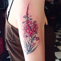 a woman with a flower tattoo on her arm