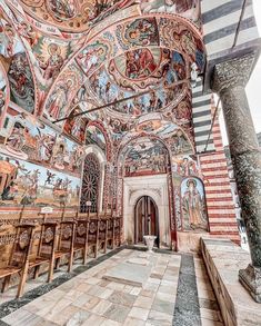 the interior of an old church with paintings on the walls