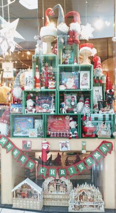 a christmas display in a store window filled with lots of holiday decorations and gifts for sale