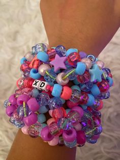 a close up of a person's wrist with bracelets and charms on it