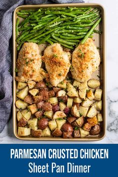 chicken and potatoes with parmesan crusted chicken sheet pan dinner on a marble table