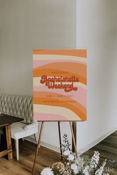 a sign sitting on top of a wooden easel in front of a white couch