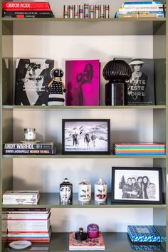 a book shelf filled with books and pictures on top of eachother's shelves