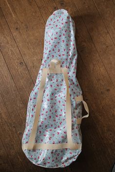 a blue and white bag sitting on top of a wooden floor