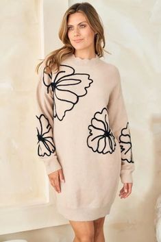 This whimsical sweater dress is an ode to simpler times. Delicate floral embroidery and scalloped accents evoke memories of carefree afternoons in a sun-dappled meadow. At the same time, its cozy knit fabric and effortless pullover silhouette keep you grounded in the present. Destined to become your go-to piece for lazy weekends and casual gatherings with friends, this lightweight wonder transitions gracefully. Whether you pair it with sneakers for a retro-inspired look or heeled booties for nig Cozy Cream Sweater Dress For Spring, Cozy Beige Sweater Dress For Spring, Casual Cream Sweater Dress For Spring, Cozy Jacquard Knit Sweater For Spring, Casual Soft Knit Spring Dresses, Fall Floral Applique Crew Neck Sweater, Spring Beige Sweater Dress For Loungewear, Spring Long Sleeve Soft Knit Sweater Dress, Soft Knit Long Sleeve Sweater Dress For Spring