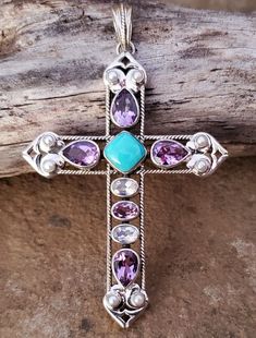 New NICKY BUTLER 925 Sterling Silver ONE OF A KIND Mojave Turquoise, African Amethyst, Moonstone, and Pearl Multi Gem Designer Signed Large 3-1/8" Cross Pendant. Comes with original NB romance card and black velvet gift pouch. Shipped FAST with USPS First Class Package. Shipping includes tracking. 📬💌 I'm very proud of my Nicky Butler collection and strive for 100% Positive Feedback. Always happy to combine shipping. ⭐⭐⭐⭐⭐ Purple Southwestern Jewelry For Gifts, Purple Southwestern Jewelry For Gift, Purple Southwestern Style Jewelry For Gift, Southwestern Style Purple Jewelry For Gift, Purple Multi-stone Bohemian Jewelry, Purple Bohemian Multi-stone Jewelry, Spiritual Turquoise Necklace With Large Stone, Spiritual Turquoise Gemstones With Accents, Gift Pouch