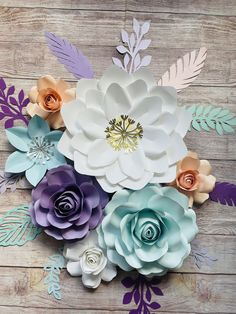 paper flowers are arranged on a wooden surface