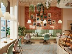 the interior of a restaurant with green chairs and tables in front of a brick wall