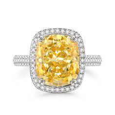 a fancy cushion cut yellow diamond ring set in 18k white gold with diamonds around the band